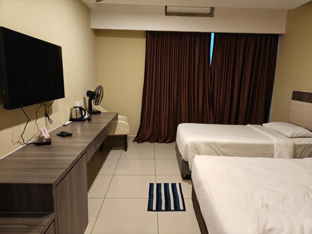 a hotel room with two beds and a television at Grand Ion Delemen by 91 Homestay in Genting Highlands