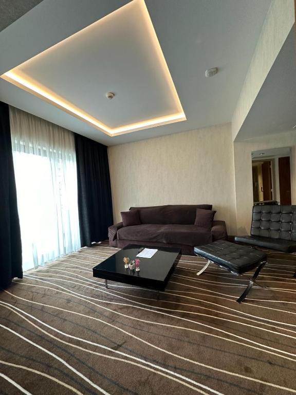 a living room with a couch and a table at Cihangir Hotel Bosphorus in Istanbul