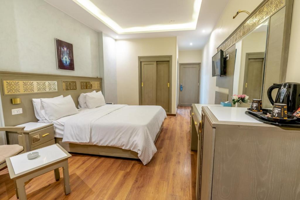 A bed or beds in a room at Lotus Luxor Hotel