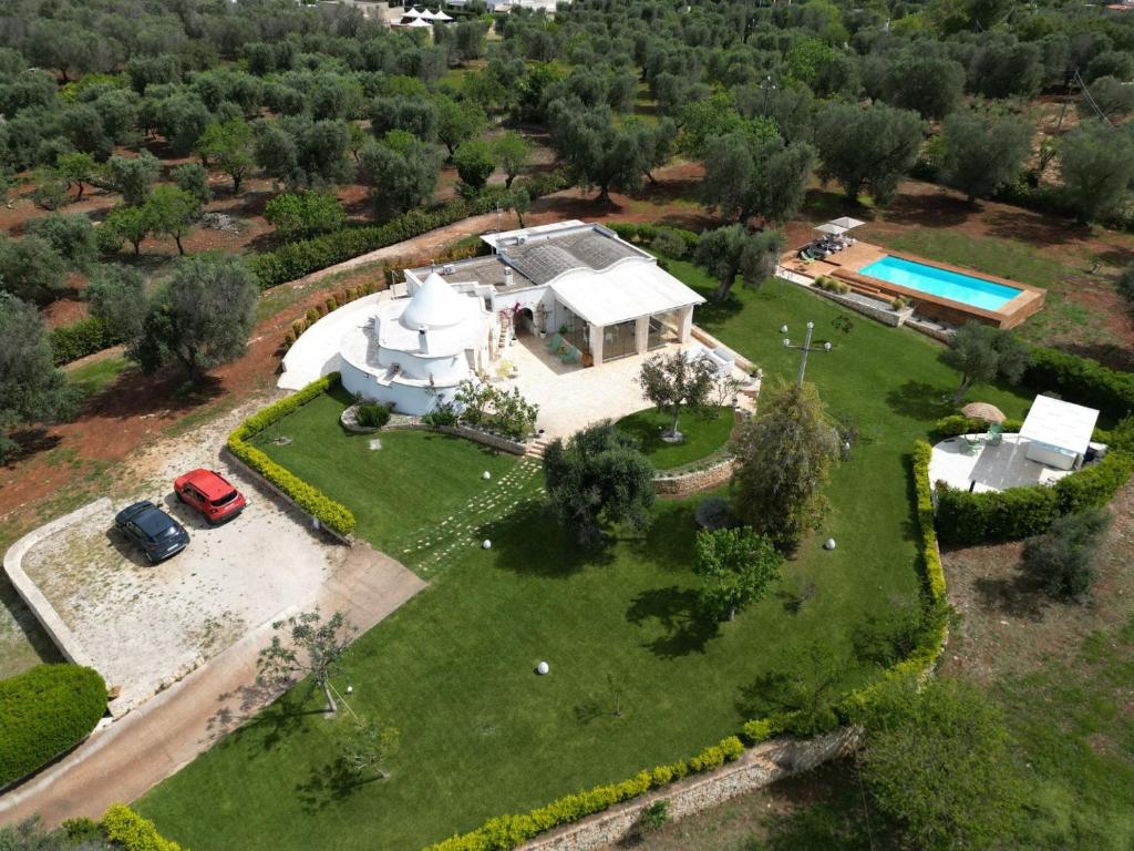 an aerial view of a house with a pool at Trullo dei Sogni con Piscina e Jacuzzi in San Michele Salentino