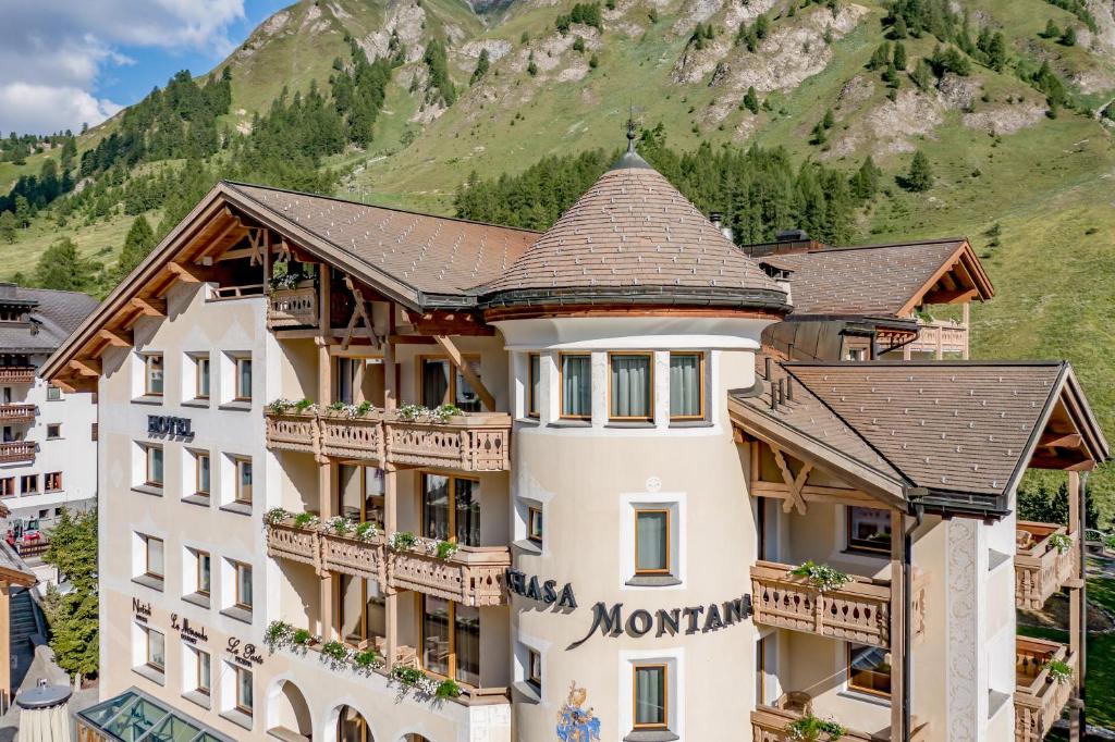 a hotel with a mountain in the background at Relais & Châteaux Chasa Montana in Samnaun