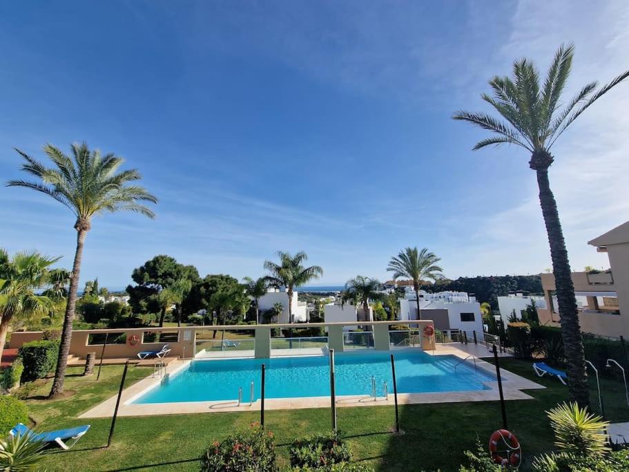 a view of a swimming pool with palm trees at La Resina 3BD 2 BTH - SUN&RELAX in Estepona