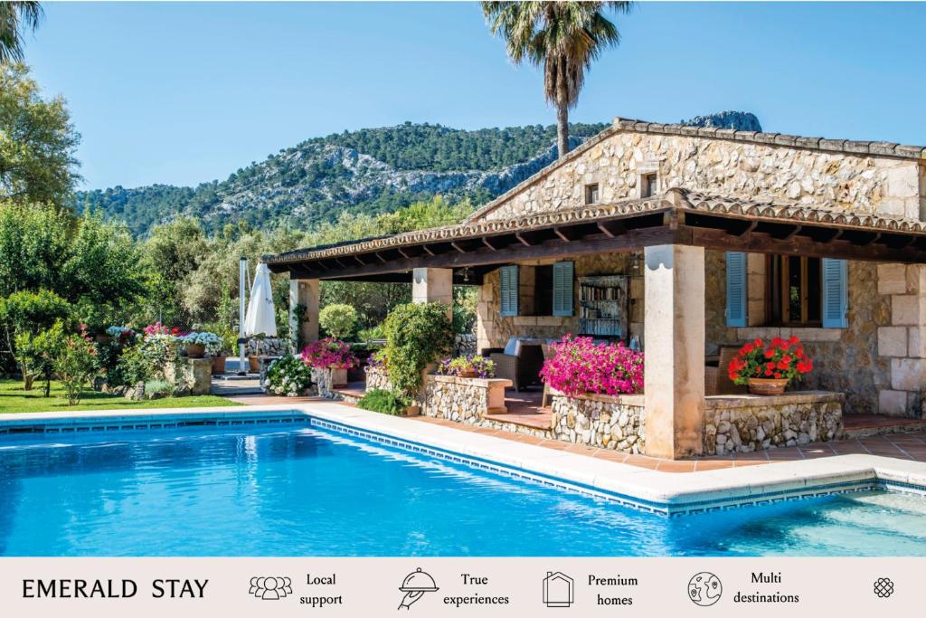a villa with a swimming pool in front of a house at Villa Alyvos Pollensa - BY EMERALD STAY in Pollença