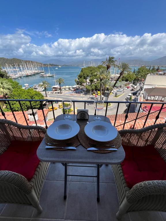 a table on a balcony with a view of the ocean at MEK HARBOUR view in Fethiye