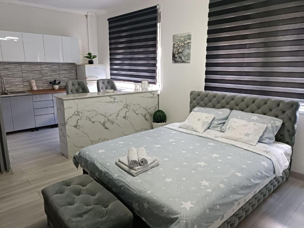 a bedroom with a bed with shoes on it at Apartman u centru in Šid