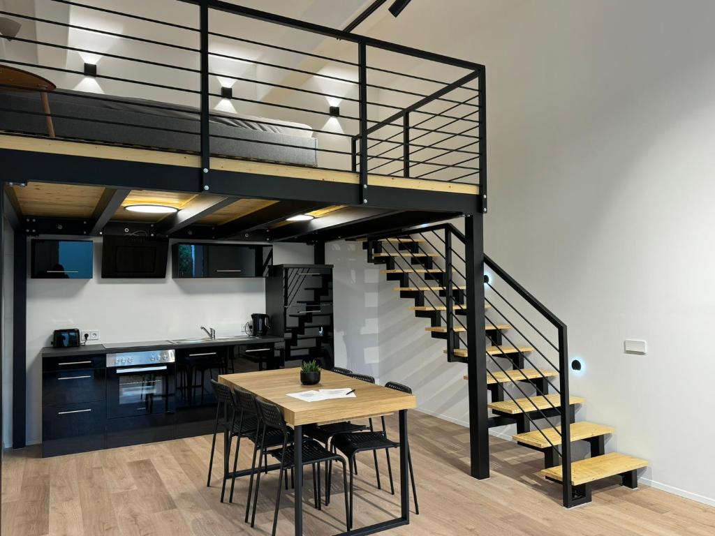 a kitchen and dining room with a staircase and a table at Loft Neunkirchen in Neunkirchen am Brand