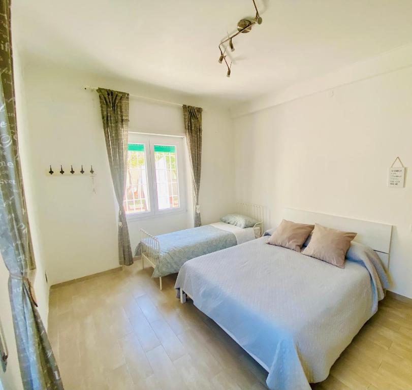 a bedroom with two beds and a window at Enjoy in Lido di Ostia