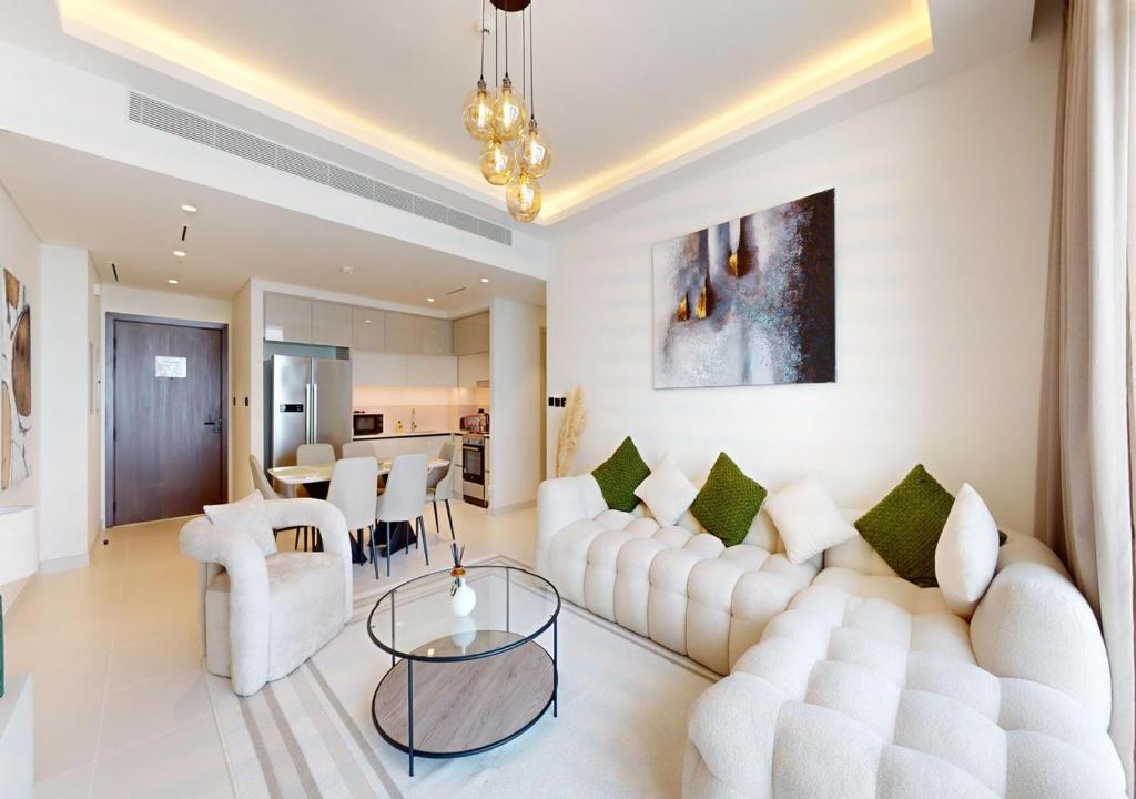 a living room with a white couch and a table at Amazing View Marina Vista High Floor in Dubai