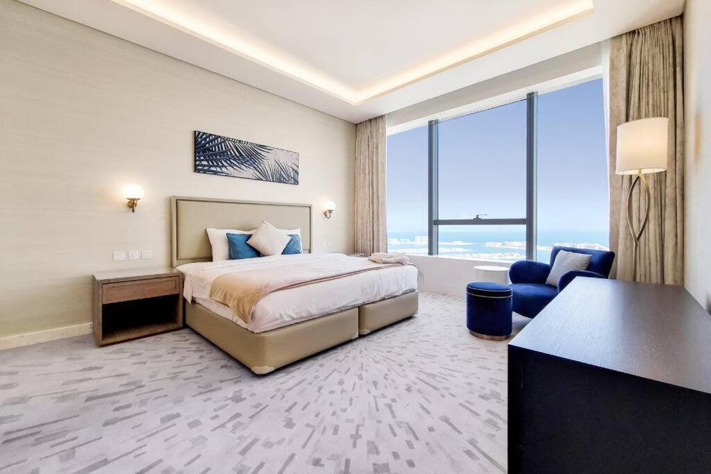 a hotel room with a bed and a desk at Splendor 1BR with Breathtaking Palm Views in Dubai