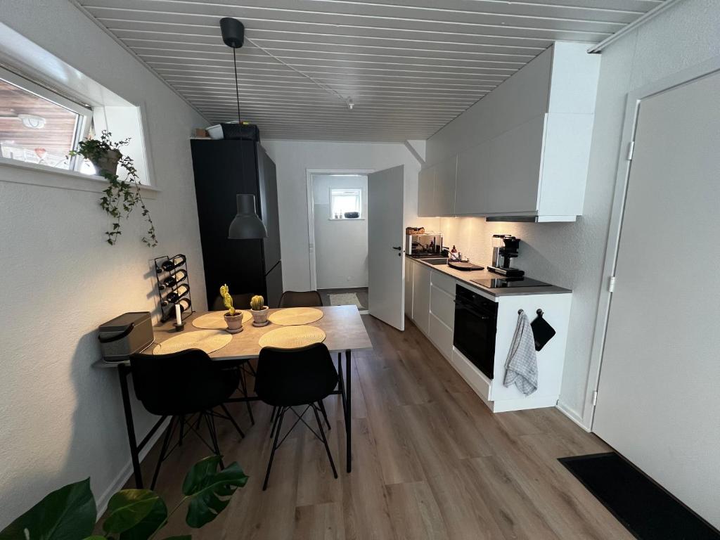 een keuken met een tafel en stoelen in een kamer bij The Old Hotel Silkeborg - S1 in Silkeborg