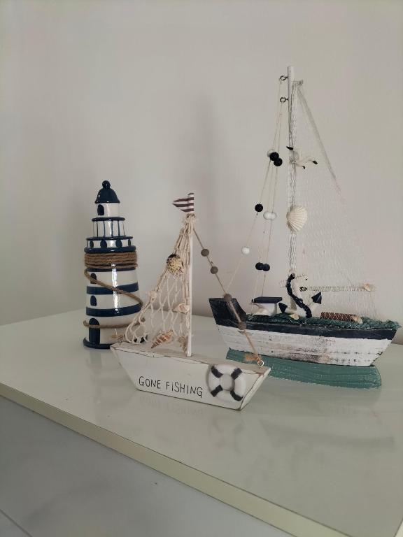 a shelf with a toy boat and a lighthouse at Flore's House Ostuni in Villanova di Ostuni