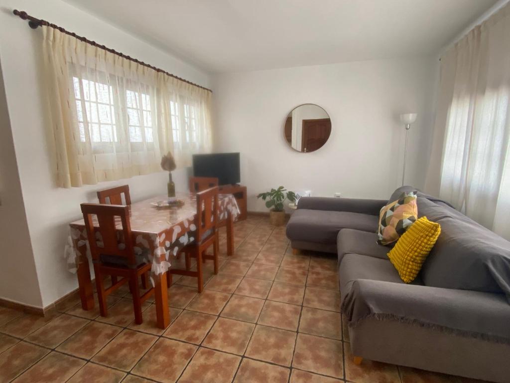 a living room with a couch and a table at Casa Rosa in Famara
