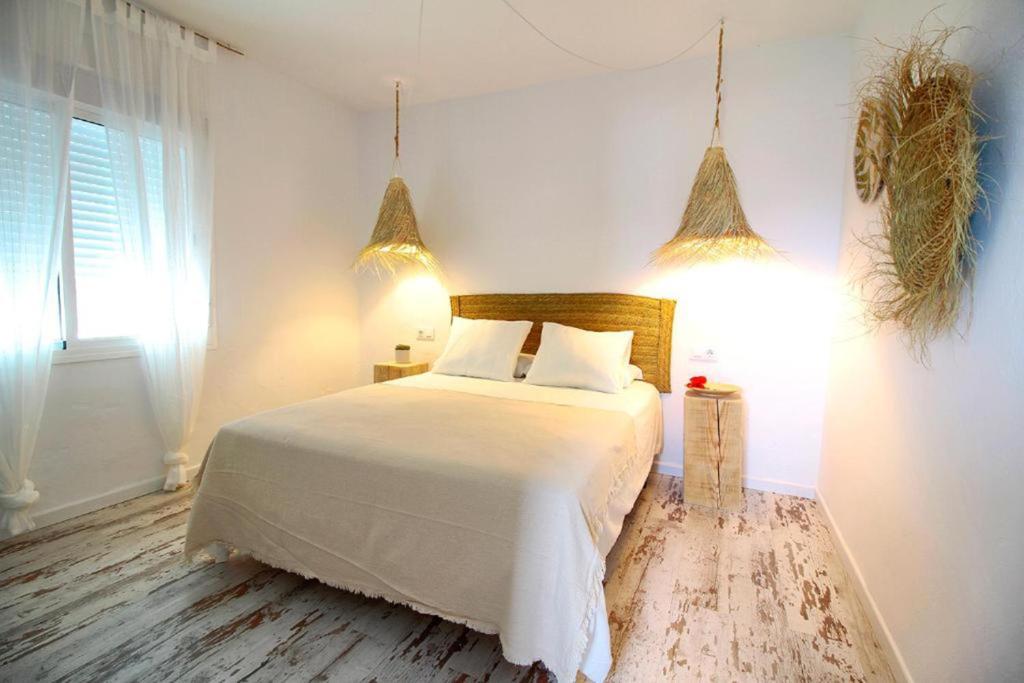 um quarto com uma cama branca e uma janela em Zahora Beach Room em Zahora