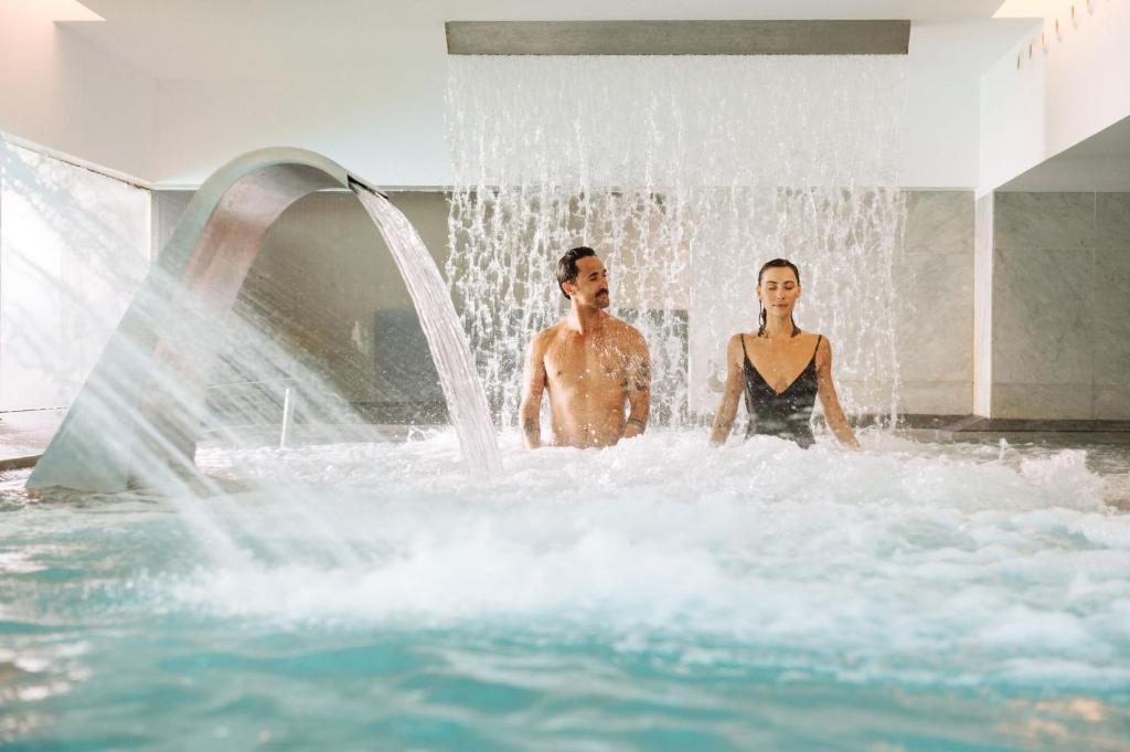 a man and a woman standing in a water fountain at Arrecife Gran Hotel & Spa in Arrecife
