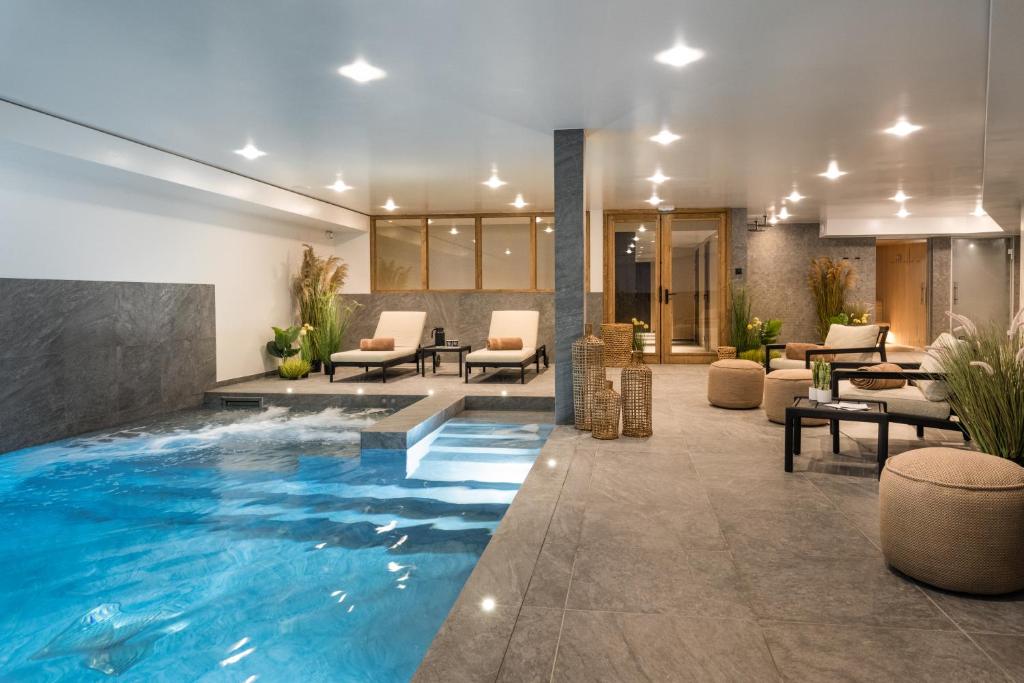 a hotel lobby with a large swimming pool at Falcon Lodge by Alpine Residences in Méribel