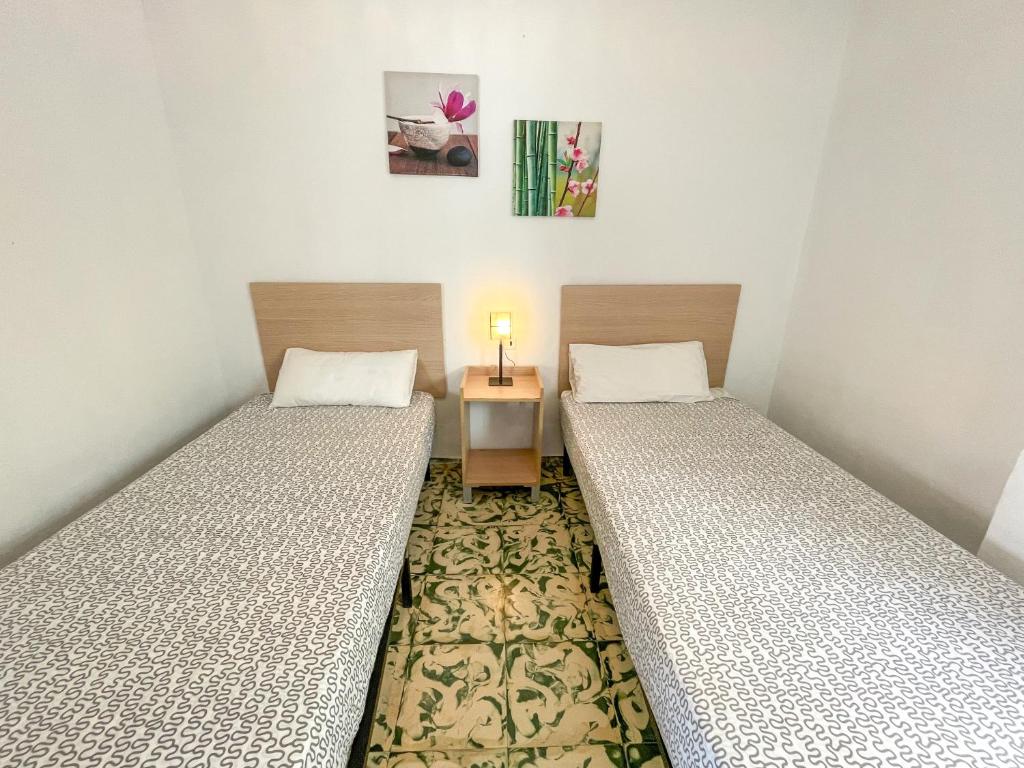 Postel nebo postele na pokoji v ubytování Apartamentos Gandia-Daimuz 3000