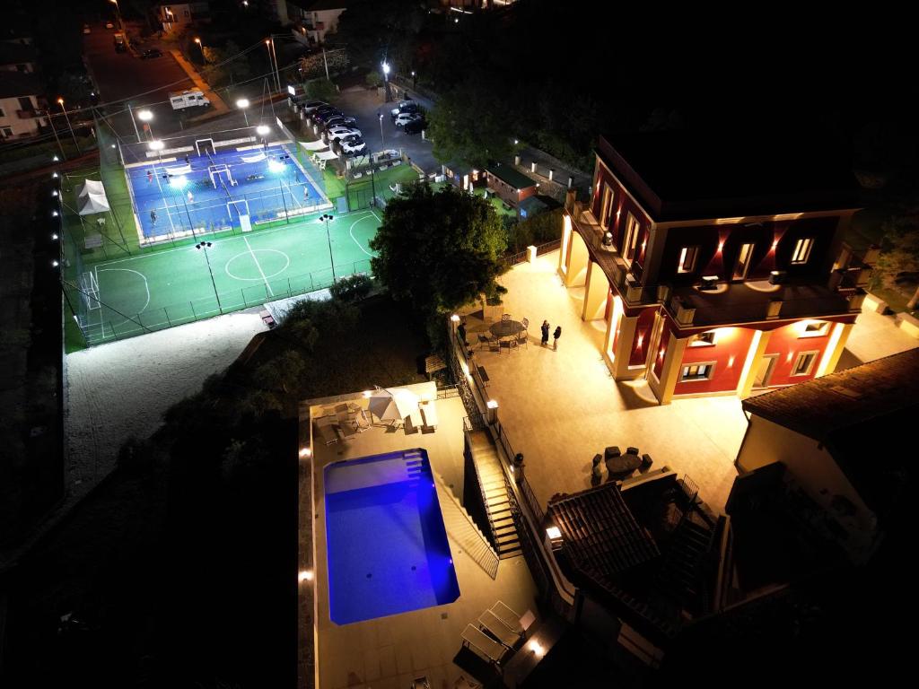 an overhead view of a tennis court at night at B&B Badimà in Fleri