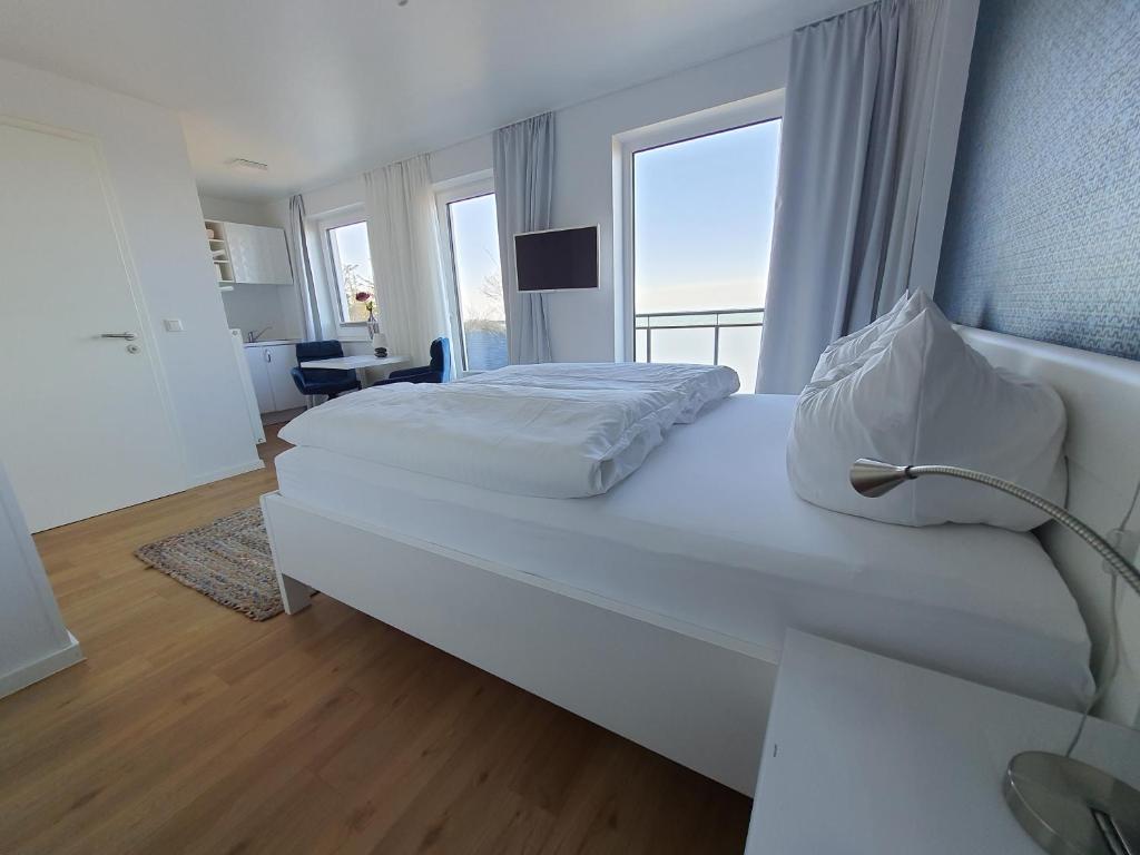 Postel nebo postele na pokoji v ubytování Haus Achtern Diek in erster Reihe am Meer