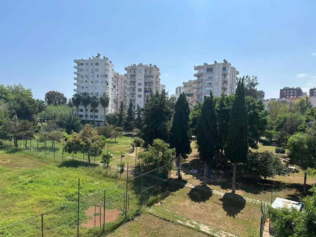 a park in a city with tall buildings at Loca Marin in Mersin