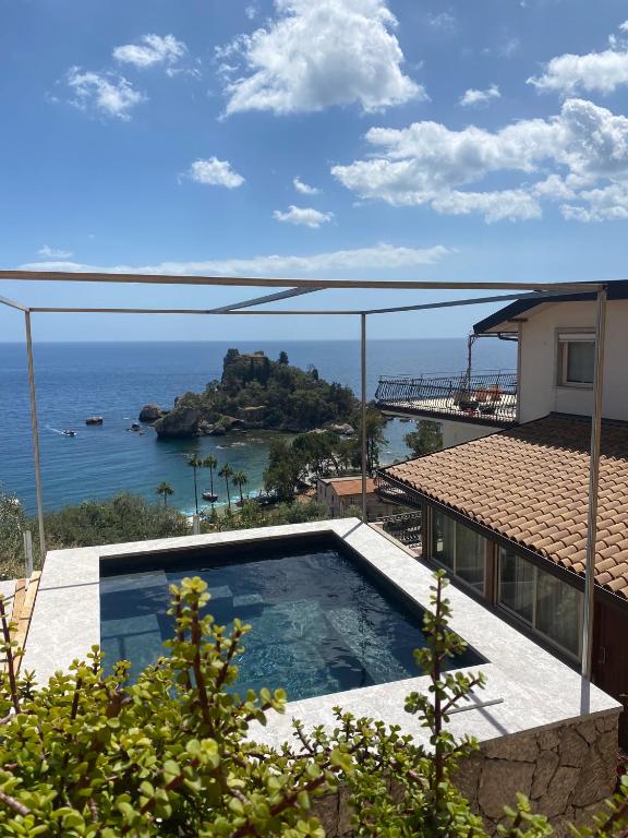 a view of the ocean from a house with a swimming pool at 202 luxury terrace view in Taormina