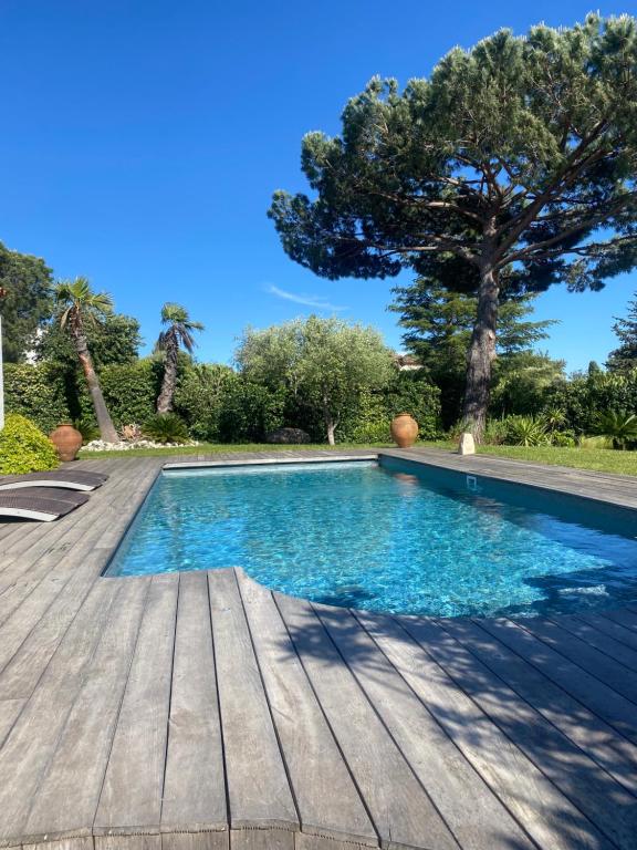 a swimming pool on a wooden deck at Villa 55 in Grimaud