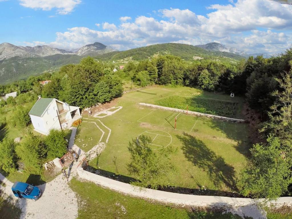 an aerial view of a field with a soccer field at 3 bedrooms chalet with enclosed garden and wifi at Herceg Novi 2 km away from the slopes in Herceg-Novi