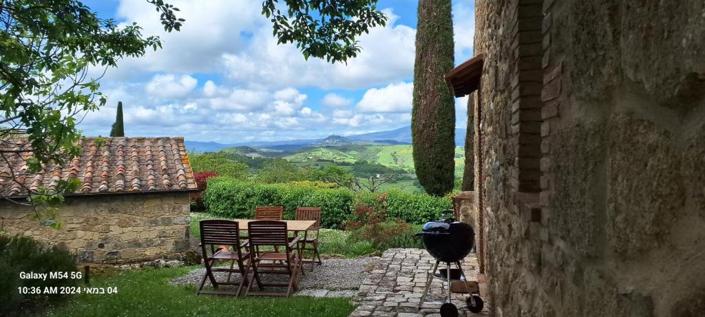 a patio with chairs and a table with a view at Borgo Fastelli in Sarteano