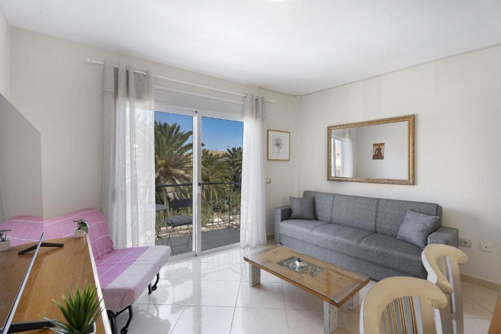 a living room with a couch and a table at Nido Andrea in San Isidro