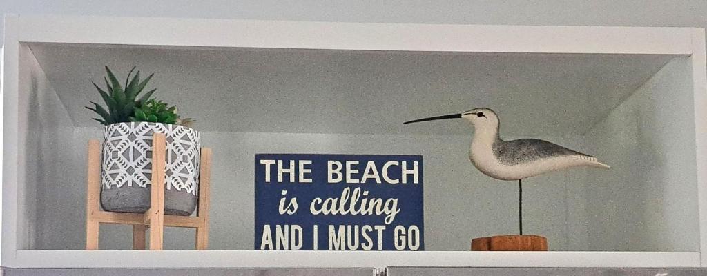 a sign on a shelf with a bird on it at School Street Haven - 4 bedroom 2 bath sleeps 10 and is centrally located to downtown South Haven in South Haven
