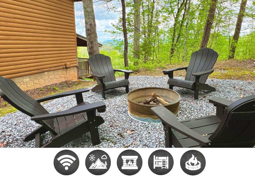 three chairs and a fire pit next to a cabin at Dolly's # 1 condo in Sevierville