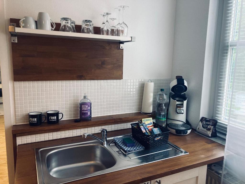 a kitchen with a sink and a counter top at FREE Apartment - Bei der Stadtmauer in Reutlingen