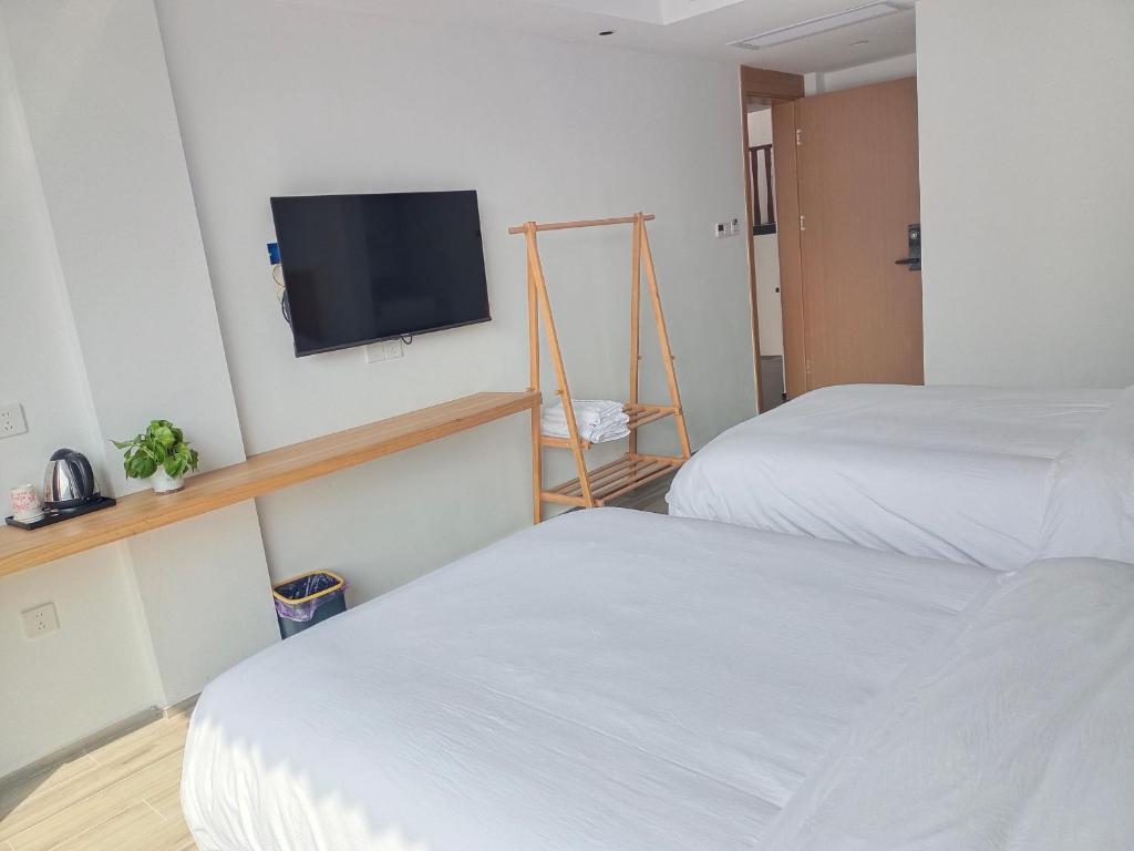 Postel nebo postele na pokoji v ubytování Huang Mountain Wangfeng Hotel