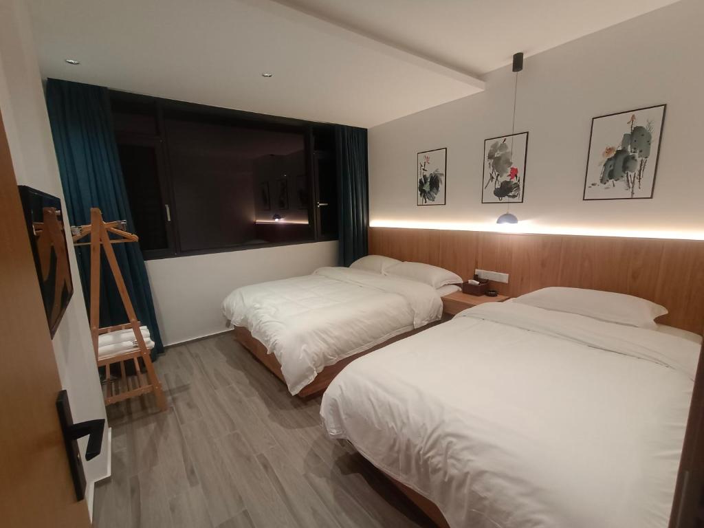 Postel nebo postele na pokoji v ubytování Huang Mountain Wangfeng Hotel