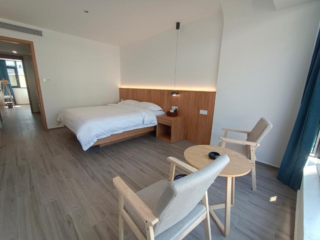 Postel nebo postele na pokoji v ubytování Huang Mountain Wangfeng Hotel