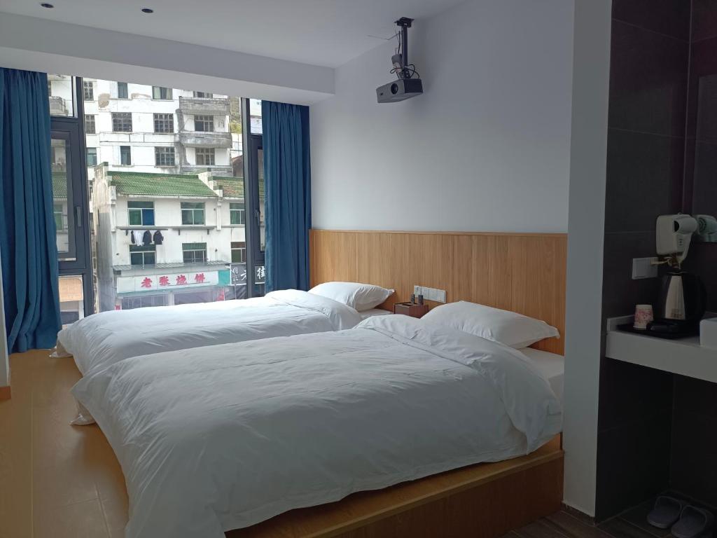 Postel nebo postele na pokoji v ubytování Huang Mountain Wangfeng Hotel
