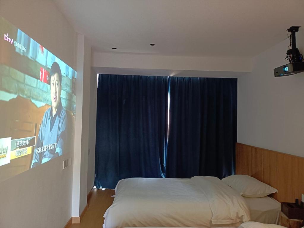 Postel nebo postele na pokoji v ubytování Huang Mountain Wangfeng Hotel