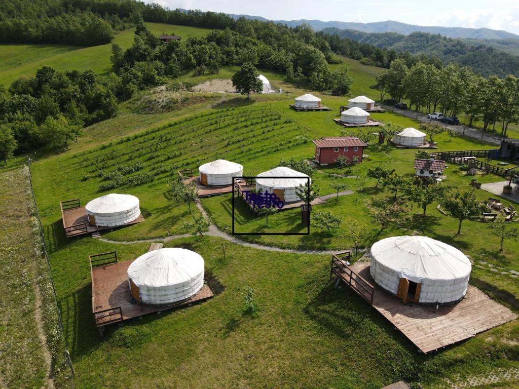 an aerial view of a group of domes in a field at Società Agricola Cacigolara in Borgo Val di Taro