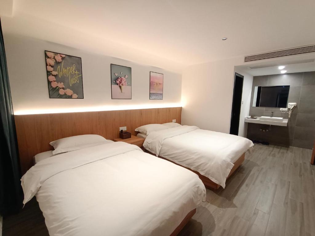 Postel nebo postele na pokoji v ubytování Huang Mountain Wangfeng Hotel