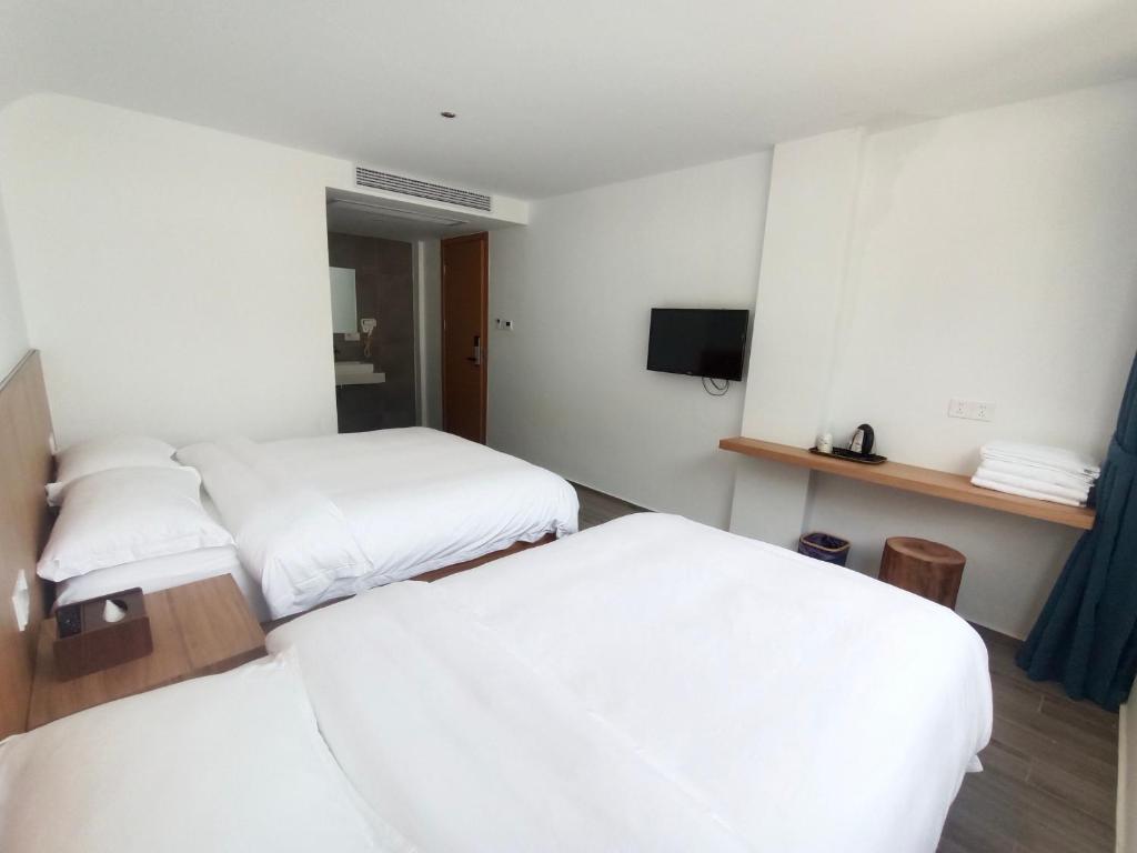 Postel nebo postele na pokoji v ubytování Huang Mountain Wangfeng Hotel