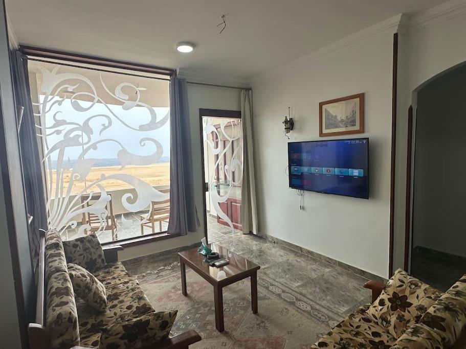 a living room with a couch and a window at Relaxing apartment overlooking the sea and 2 terrace on the sea in Quseir