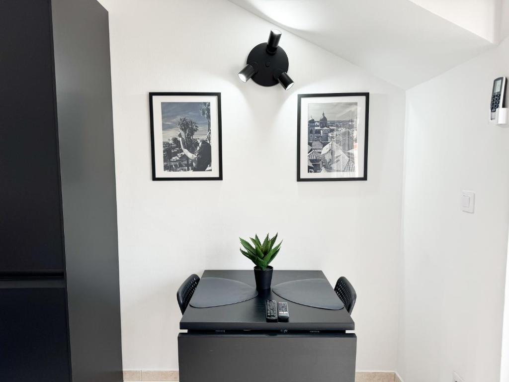 an office with a desk and two pictures on the wall at Black n’ White in Dubrovnik