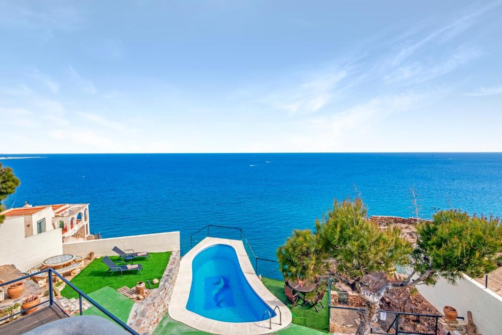 a view of the ocean from a house at Villa Infinity sea views I Pool I BBQ I Jacuzzi in Almería