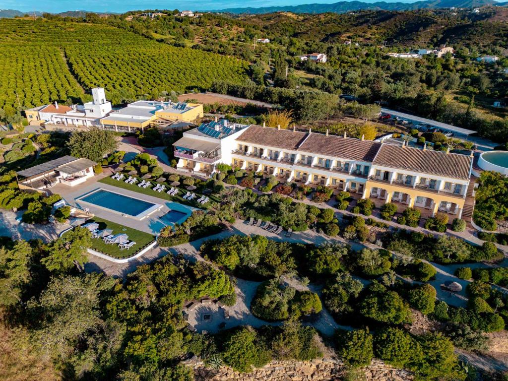 an aerial view of a mansion with a swimming pool at Hotel Rural Quinta do Marco - Nature & Dining in Tavira