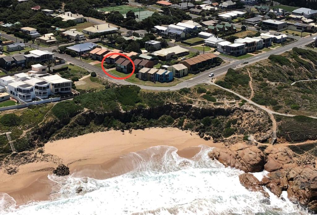 an aerial view of a beach with a red circle at Southern Sands' Beachfront Apartment in Port Elliot