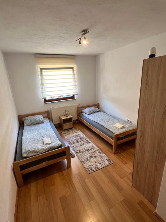 a room with two beds and a window at SA Apartment in Sarajevo