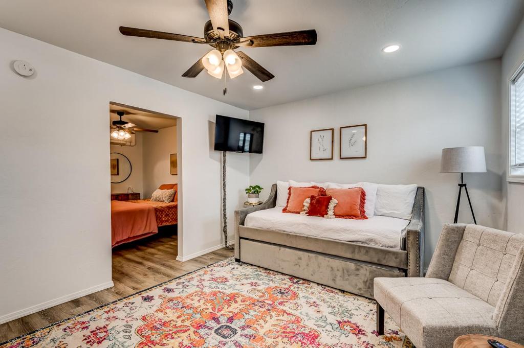 a living room with a couch and a ceiling fan at Charming Getaway in Stillwater in Stillwater