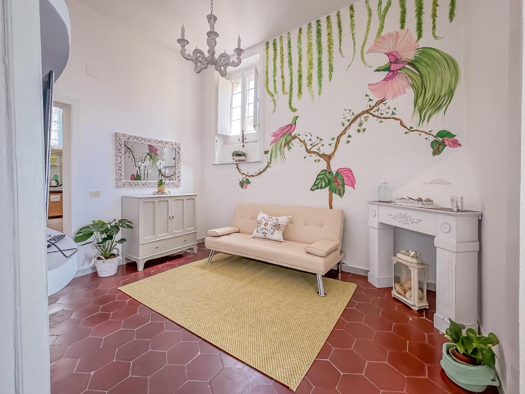 a living room with a couch and a tree on the wall at Franci House in Sant'Agnello