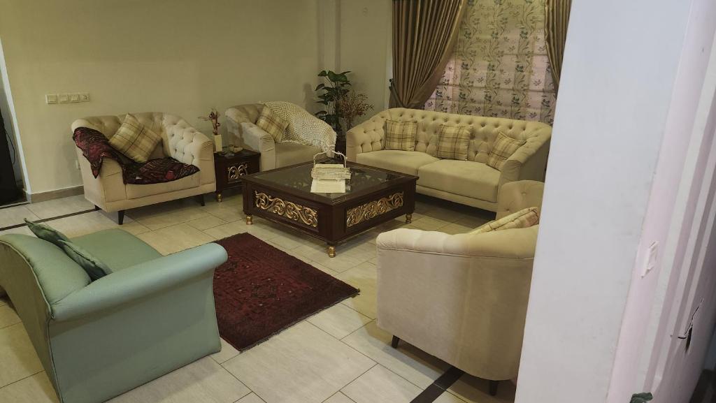 a living room with couches and a coffee table at Modern luxury home located in centre of Islamabad in Islamabad