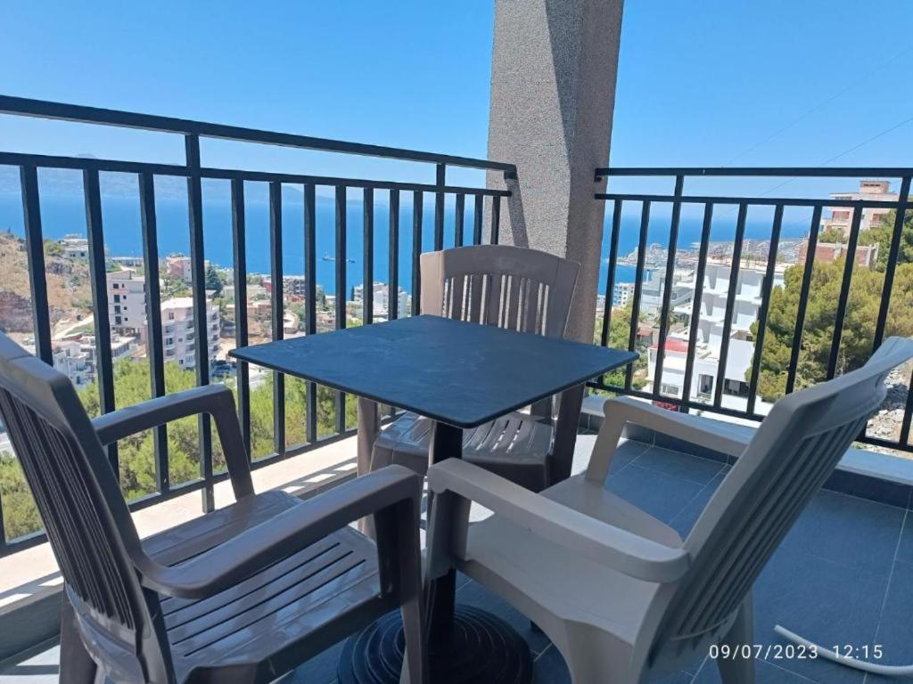 a table and two chairs on a balcony at Davids Apartments in Sarandë
