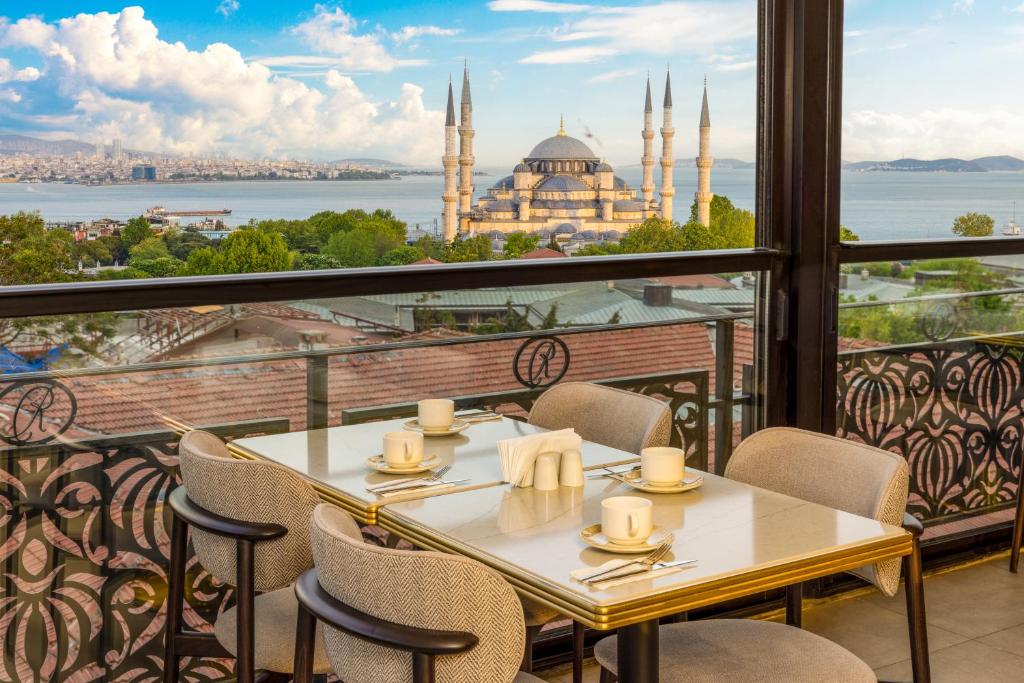 a table on a balcony with a view of the mosque at Rast Hotel Sultanahmet in Istanbul
